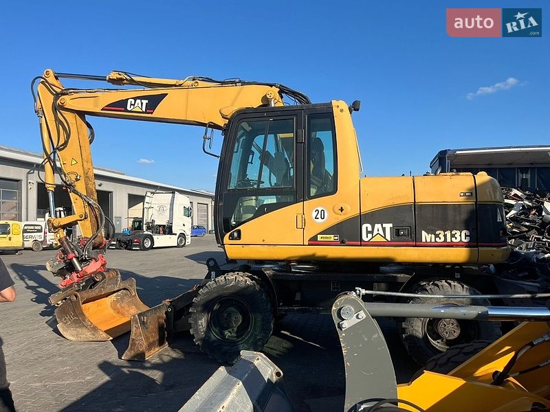 Колесный экскаватор Caterpillar 313 2003 в Косове