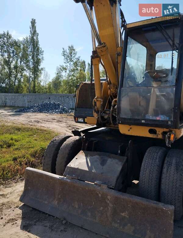 Екскаватор навантажувач Caterpillar M312 2002 в Житомирі